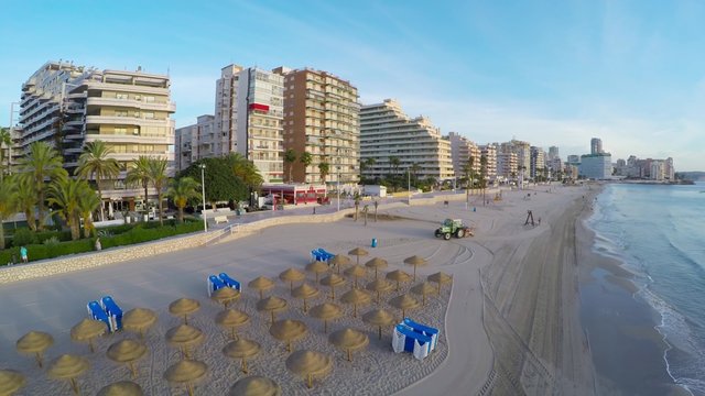 Aerial view of Calpe, Costa Blanca during the day. Popular summer resort in Spain with mediterranean sea and Las Salinas lake, mountains at the background, skyscrapers - hotels, apartments.