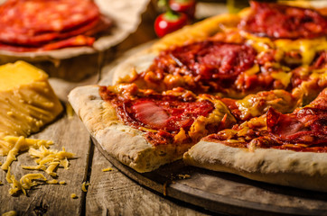 Rustic salami pizza with cheddar cheese and chorizo