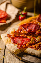 Rustic salami pizza with cheddar cheese and chorizo