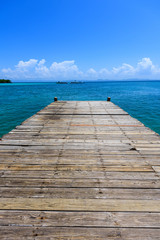 Fototapeta premium wooden bridge juts out into of the sea