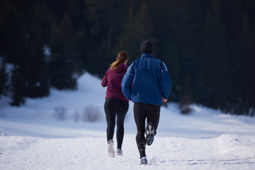 couple jogging outside on snow