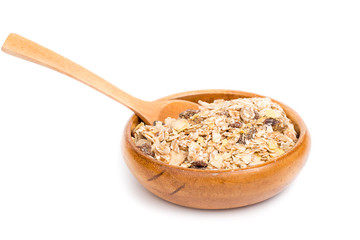 Muesli in bowl and wooden spoon on white background