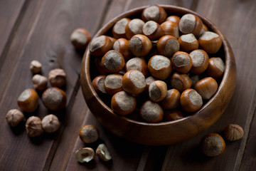 Close-up of hazelnuts in a wooden bowl, selective focus