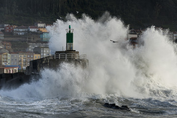 Fototapeta na wymiar Breaking wave in the lighthouse of La Guardia, Galicia, Spain