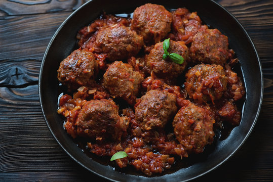 Frying pan with meatballs in tomato sauce, studio shot, close-up
