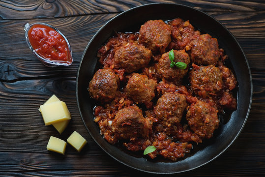 Above view of meatballs with tomato sauce and parmesan cheese
