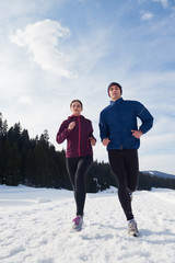 Fototapeta na wymiar couple jogging outside on snow
