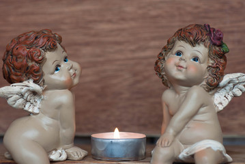 Boy and girl angels with candle