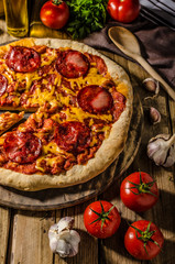 Rustic salami pizza with cheddar cheese and chorizo