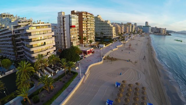 Aerial view of Calpe, Costa Blanca during the day. Popular summer resort in Spain with mediterranean sea and Las Salinas lake, mountains at the background, skyscrapers - hotels, apartments.