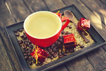 Coffee cup and christmas decoration on wooden table background
