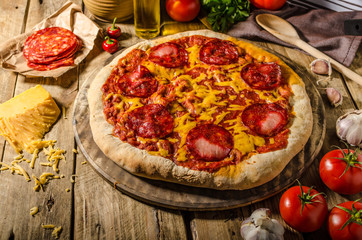 Rustic salami pizza with cheddar cheese and chorizo