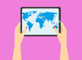 woman's hand holding a tablet with world map on the screen