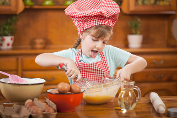 funny young girls mix eggs in the kitchen