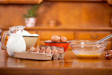 flour in bowl scoop egs and jug with milk