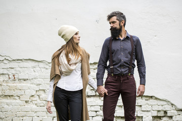 Young couple near wall