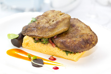 foie gras with corn bread on a table in a restaurant