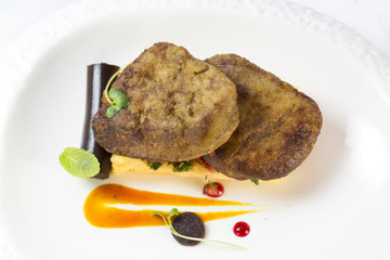 foie gras with corn bread on a table in a restaurant