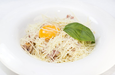 spaghetti with eggs decorated with greenery on a white background