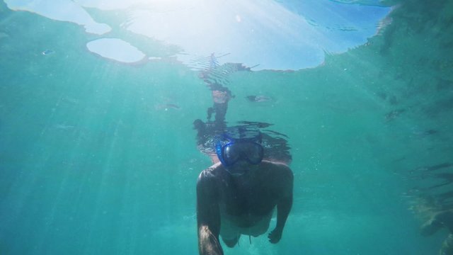 Snorkeling. Looking for adventure. Underwater selfie video shot. 