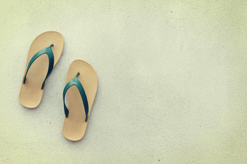 yellow and green slippers on cement floor - with a retro effect.