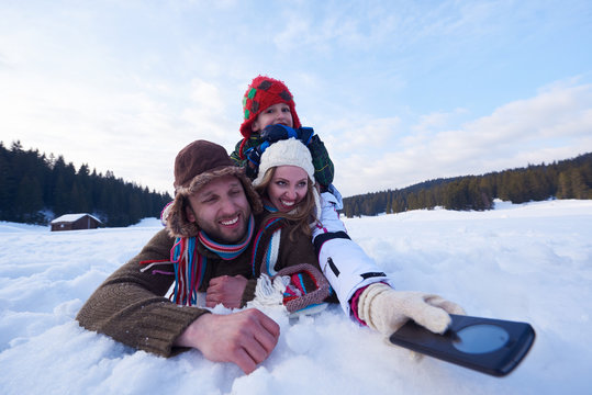 romantic couple have fun in fresh snow and taking selfie