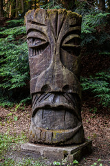 Huge mossy totem made from a tree trunk.