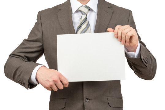 Businessman holding blank paper on white