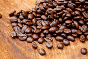 Roasted coffee beans on wood. (Arabica coffee)