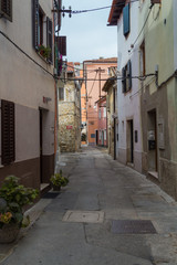 Fototapeta na wymiar Small medieval deserted seaside European street.