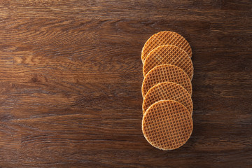 Waffles with caramel on wood