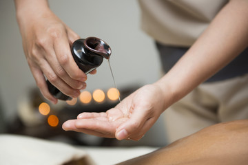 chiropractor pour oil into hand for massage © Sunanta