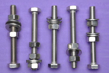 Bolts and nuts on violet background