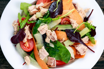 Tuna salad with Spinach, rocket, red ruby chard, tomatoes, cucumbers, carrot, red onion