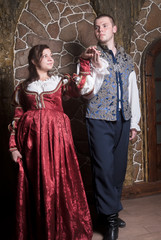 Attractive couple in retro dresses dance