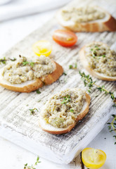 Bruschetta with green olives paste, tapenade on a white background