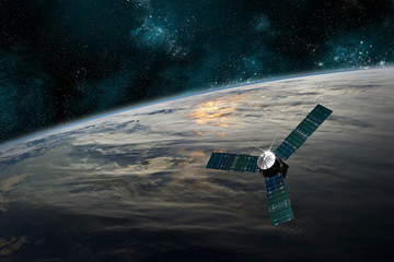 Naklejka na ściany i meble A satellite orbits Earth - Elements of this image furnished by NASA.