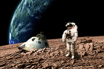 Fototapeta na wymiar A stranded astronaut surveys his situation - Elements of this image furnished by NASA.