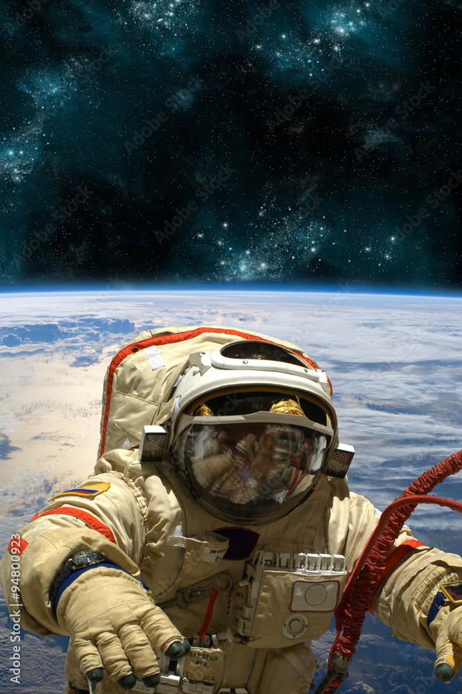 Wall mural a cosmonaut floats in space. - elements of this image furnished by nasa.