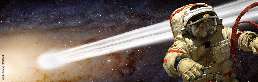 Poster a cosmonaut has a comet pass close to him - elements of this image furnished by nasa.