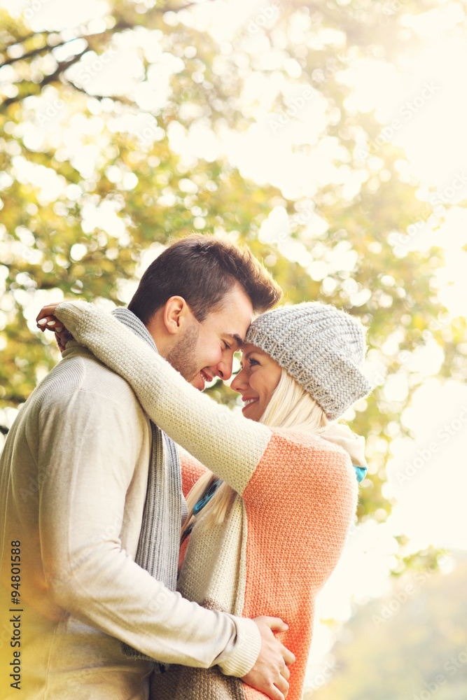 Wall mural young romantic couple in the park in autumn