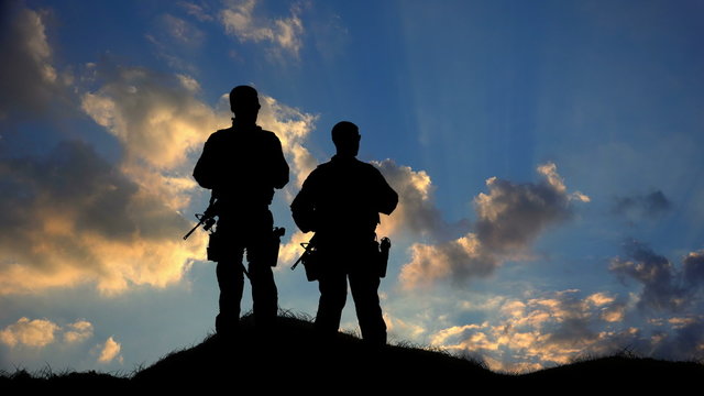Two Soldiers Silhouette Standing Against Clouds HD