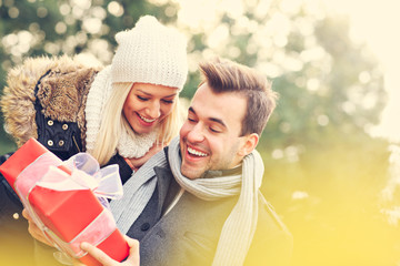 Young couple with a present in the park