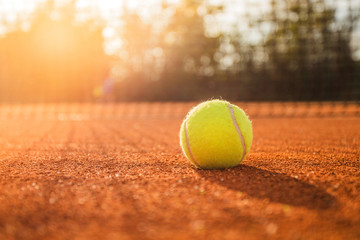 Tennis ball on clay court