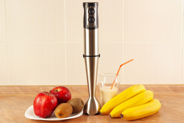 Fresh fruit, glasses and a blender to prepare milkshake