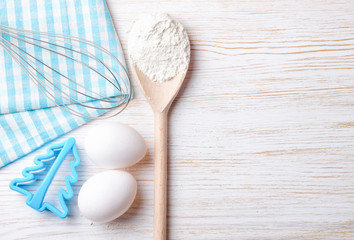 Baking ingredients on white wooden background