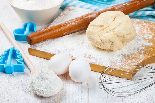 Baking ingredients on white wooden background