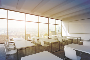 Fototapeta A modern panoramic classroom with New York view. White tables and white chairs. 3D rendering. Sunset. Toned image. obraz