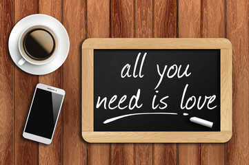 coffee, phone  and chalkboard with word all you need is love