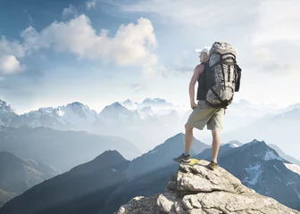 Foto auf Acrylglas Tourist on the peak of high rocks. Sport and active life concept. © biletskiyevgeniy.com